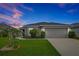 Charming single-story home features a well-maintained lawn and an attached two-car garage at 4505 Hummingbird Ln, Haines City, FL 33844