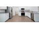 Modern kitchen with stainless steel appliances, white cabinetry, and hard wood floors at 4505 Hummingbird Ln, Haines City, FL 33844