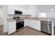 Modern kitchen featuring stainless steel appliances, stone countertops, and an open floorplan at 4505 Hummingbird Ln, Haines City, FL 33844