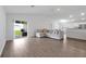Open concept living room featuring hard wood floors and sliding glass door to the patio at 4505 Hummingbird Ln, Haines City, FL 33844