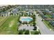 This aerial showcases the community pool, playground, and playing field areas with the beautiful homes in the distance at 4505 Hummingbird Ln, Haines City, FL 33844