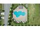 Overhead aerial view of a community swimming pool with an unusual amoeba-like shape and surrounding lounge seating at 4505 Hummingbird Ln, Haines City, FL 33844