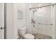 Updated bathroom featuring a glass enclosed tiled shower and modern commode at 4570 Tower Pine Rd # Ge, Orlando, FL 32839