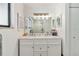 Clean bathroom features a dual sink vanity with decorative lighting above a large mirror at 4570 Tower Pine Rd # Ge, Orlando, FL 32839