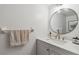 Clean bathroom with a vanity sink, round mirror, and modern fixtures, offering a refreshing and functional space at 4570 Tower Pine Rd # Ge, Orlando, FL 32839