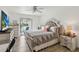 Comfortable bedroom showcasing a lake view, a stylish bed with a tufted headboard, and cozy decor, perfect for relaxation at 4570 Tower Pine Rd # Ge, Orlando, FL 32839