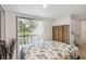 Cozy bedroom featuring a floral bedspread, natural light, and neutral decor, creating a peaceful and restful retreat at 4570 Tower Pine Rd # Ge, Orlando, FL 32839