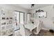 Stylish dining area with white table and chairs, open to patio, and modern decor at 4570 Tower Pine Rd # Ge, Orlando, FL 32839