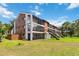 Condominium building with screened-in patios overlooking the well-manicured lawn at 4570 Tower Pine Rd # Ge, Orlando, FL 32839
