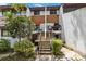 Townhouse with a concrete staircase leading to the entrance, with attractive landscaping at 4570 Tower Pine Rd # Ge, Orlando, FL 32839