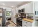 Stylish kitchen showcasing white cabinets, stainless steel appliances, and modern finishes, creating a clean and functional space at 4570 Tower Pine Rd # Ge, Orlando, FL 32839