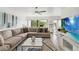 Spacious living room with large sectional sofa, modern decor, and scenic water views at 4570 Tower Pine Rd # Ge, Orlando, FL 32839