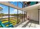 Screened porch with chairs overlooking the lake offers relaxing outdoor living at 4570 Tower Pine Rd # Ge, Orlando, FL 32839
