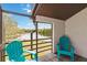 Cozy screened porch offers a serene view of the lake with two comfy chairs at 4570 Tower Pine Rd # Ge, Orlando, FL 32839