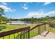 Picturesque lake view from the outdoor deck offers a tranquil and scenic vista at 4570 Tower Pine Rd # Ge, Orlando, FL 32839