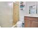 Bathroom featuring glass door shower, neutral tile, and a modern vanity at 4918 Wildwood Pointe Rd, Winter Garden, FL 34787
