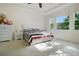 Bright bedroom with large windows, tray ceiling, and plush carpeting at 4918 Wildwood Pointe Rd, Winter Garden, FL 34787
