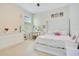 Bright bedroom with white furniture, a vanity area, and large windows for natural light at 4918 Wildwood Pointe Rd, Winter Garden, FL 34787