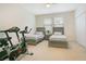 Bedroom with two beds and an exercise bike, offering a comfortable and active space at 4918 Wildwood Pointe Rd, Winter Garden, FL 34787