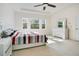 Serene bedroom featuring a tray ceiling, carpet, and ample natural light from large windows at 4918 Wildwood Pointe Rd, Winter Garden, FL 34787