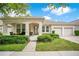 Charming single-story home featuring a well-manicured lawn, covered porch, and a two-car garage at 4918 Wildwood Pointe Rd, Winter Garden, FL 34787