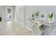 Bright foyer featuring tile flooring, a modern glass console table, and a decorative front door at 4918 Wildwood Pointe Rd, Winter Garden, FL 34787