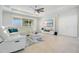 Bright living room with neutral tones, tiled floors, entertainment center, and lots of natural light at 4918 Wildwood Pointe Rd, Winter Garden, FL 34787