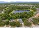 An aerial view of the home, pool, pond, and community at 512 Yellow Tail Pl, Chuluota, FL 32766