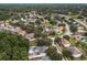 Aerial view of community and surrounding area, showing the tree coverage and lakes at 512 Yellow Tail Pl, Chuluota, FL 32766
