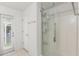 Bright, functional bathroom featuring a shower and exterior door, with a vanity and door on the left at 512 Yellow Tail Pl, Chuluota, FL 32766