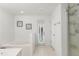 This bright bathroom has a soaking tub, and walk-in shower with plenty of natural light from the glass door at 512 Yellow Tail Pl, Chuluota, FL 32766