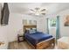 Cozy bedroom features wood-style flooring, lots of natural light, and comfortable bed at 512 Yellow Tail Pl, Chuluota, FL 32766