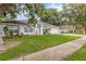 Charming single-story home with a manicured lawn, mature trees and an attached two-car garage at 512 Yellow Tail Pl, Chuluota, FL 32766