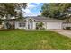 Charming single-story home with a well-manicured lawn, arched windows, and an attached two-car garage at 512 Yellow Tail Pl, Chuluota, FL 32766