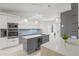 Modern kitchen featuring sleek cabinets, stainless steel appliances, a waterfall edge island, and stylish lighting at 512 Yellow Tail Pl, Chuluota, FL 32766