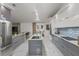 Modern kitchen features a large island with a sink, stainless steel appliances, and sleek gray and white cabinets at 512 Yellow Tail Pl, Chuluota, FL 32766