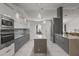 Modern kitchen with sleek gray cabinets, stainless steel appliances, a center island, and marble floors at 512 Yellow Tail Pl, Chuluota, FL 32766