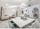 Open-concept living and dining area featuring marble floors, modern lighting, and stylish, bright decor at 512 Yellow Tail Pl, Chuluota, FL 32766