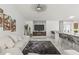 Open-concept living space featuring marble floors, a comfortable sofa, and modern accents at 512 Yellow Tail Pl, Chuluota, FL 32766