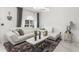 Bright living room featuring a stylish white sofa, marble floors, a modern coffee table, and elegant decor at 512 Yellow Tail Pl, Chuluota, FL 32766
