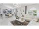 Spacious living room and dining area featuring white marble floors, modern lighting, and stylish decor at 512 Yellow Tail Pl, Chuluota, FL 32766