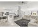 Bright, open-concept living space featuring marble floors and a stylish kitchen with modern lighting fixtures at 512 Yellow Tail Pl, Chuluota, FL 32766