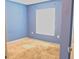 Bedroom featuring blue walls, carpeted floors, one window, and an electrical outlet near the floor at 546 Lorient Dr, Eagle Lake, FL 33839