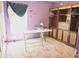 Bedroom with purple walls, carpeted floors, a window, a desk, and a built-in shelving unit at 546 Lorient Dr, Eagle Lake, FL 33839
