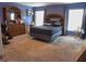 Spacious bedroom featuring blue walls, carpeted floors, two windows, and classic wood furniture at 546 Lorient Dr, Eagle Lake, FL 33839
