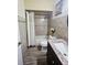 Bathroom with tiled shower and vanity with granite counter tops, complemented by wood-look flooring at 5661 Parkview Lake Dr, Orlando, FL 32821