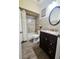 Bathroom featuring tiled shower and vanity with granite counter tops, complemented by wood-look flooring at 5661 Parkview Lake Dr, Orlando, FL 32821