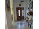 Bright foyer showcases tile flooring, elegant decor, and a charming console table with artwork at 5661 Parkview Lake Dr, Orlando, FL 32821