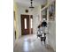 Inviting foyer featuring tiled floors, decorative accents, and a glass-topped console table with floral arrangements at 5661 Parkview Lake Dr, Orlando, FL 32821
