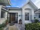 Inviting entrance with grey trim, a decorative storm door, and potted plants at 5661 Parkview Lake Dr, Orlando, FL 32821